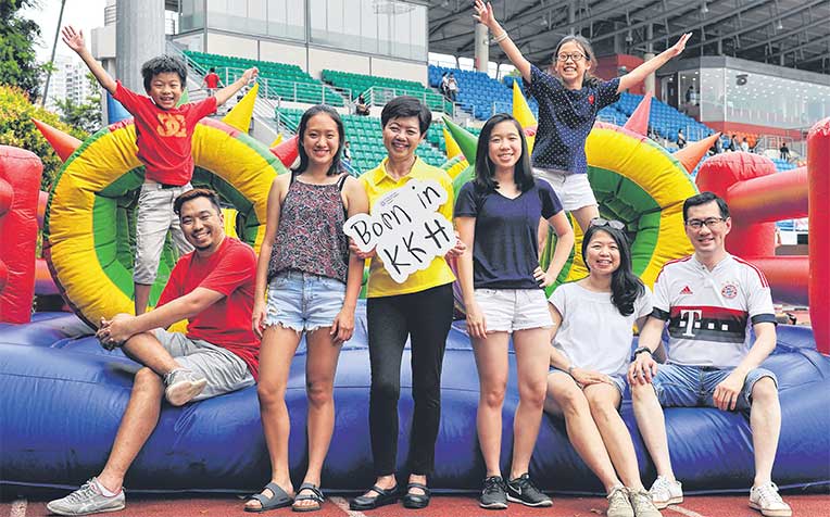 ​(in yellow) and three generations of her KKH-born family (from far left) Primary 2 pupil Callum Tam, seven; Mr Joel Tam, 41, a creative director; JC 1 student Nicole Tan, 17; Secondary 3 student Natalie Tan, 15; Primary 4 pupil Nadine Tan, 10 (the only one not born at KKH); Mrs Melissa Tan, 45, a civil servant; Mr Dennis Tan, 47, an executive vice-president at OCBC Bank; at Bishan Stadium. They joined thousands who were born at KK Women's and Children's Hospital.
