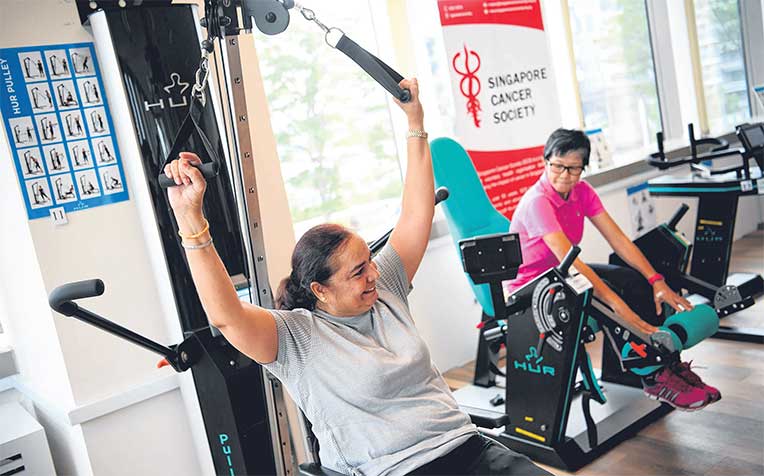  ​exercising at the gym at the Singapore Cancer Society’s rehabilitation centre in Jurong East, which was officially launched yesterday. She credits her stronger body to the programme that the centre customised for her.
