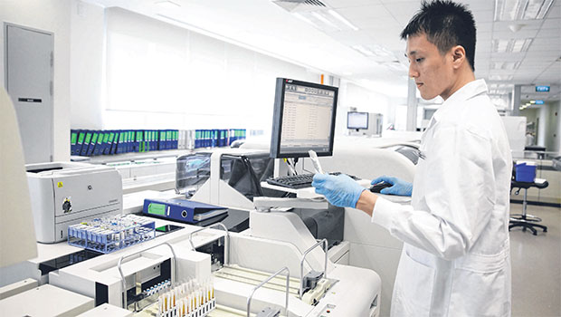 verifying a glucose test result at the Clinical Biochemistry Laboratory under Singapore General Hospital’s Department of Clinical Pathology. PHOTO GIN TAY FOR THE STRAITS TIMES