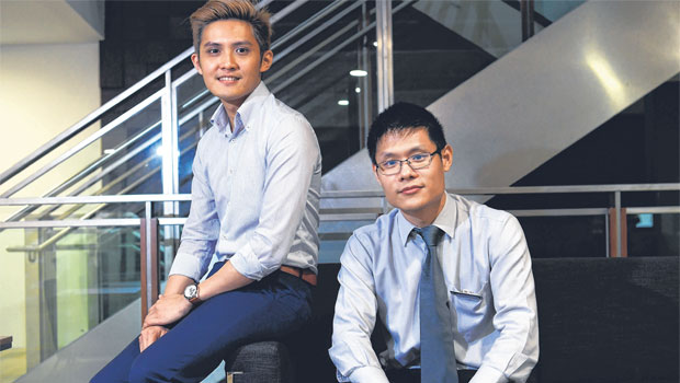 was diagnosed with the intestinal condition at the age of 18. He is seen here with SGH consultant Shim Hang Hock. Mr Koh is now better after treatment. ST PHOTO NG SOR LUAN 