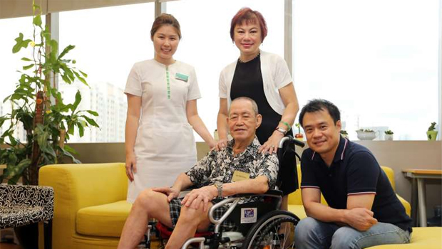  ​​(From left) Patient navigator Miss Tan, Mrs Lee and her father-in-law Mr Lee, and Mr Andrew Soh from the Tsao Foundation's Hua Mei Centre for Successful Ageing. Mr Lee attends the centre every weekday, where he is placed under an eldercare programme.  ST PHOTO JONATHAN CHOO