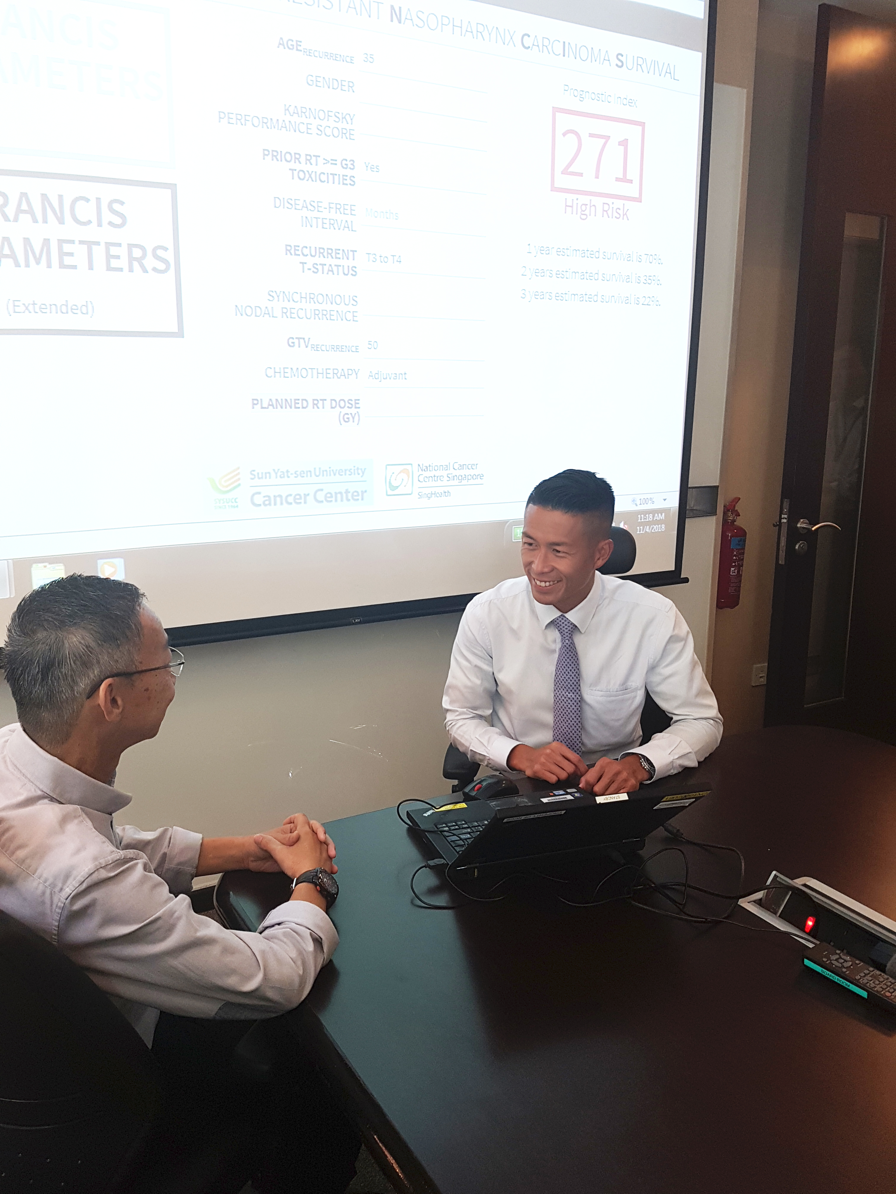  ​Dr Melvin Chua (right) demonstrating how the prognostic tool 'PRANCIS' works 